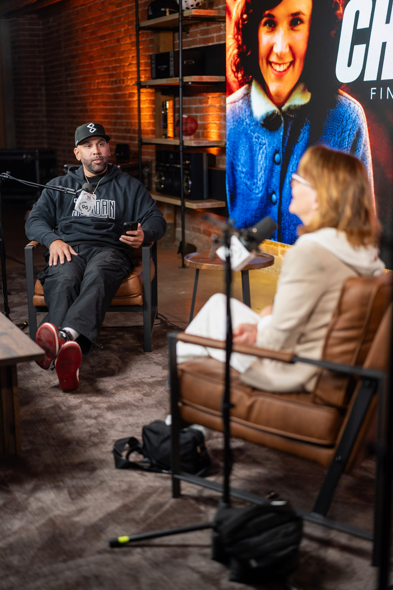 A guest and Brian facing each other during a conversation