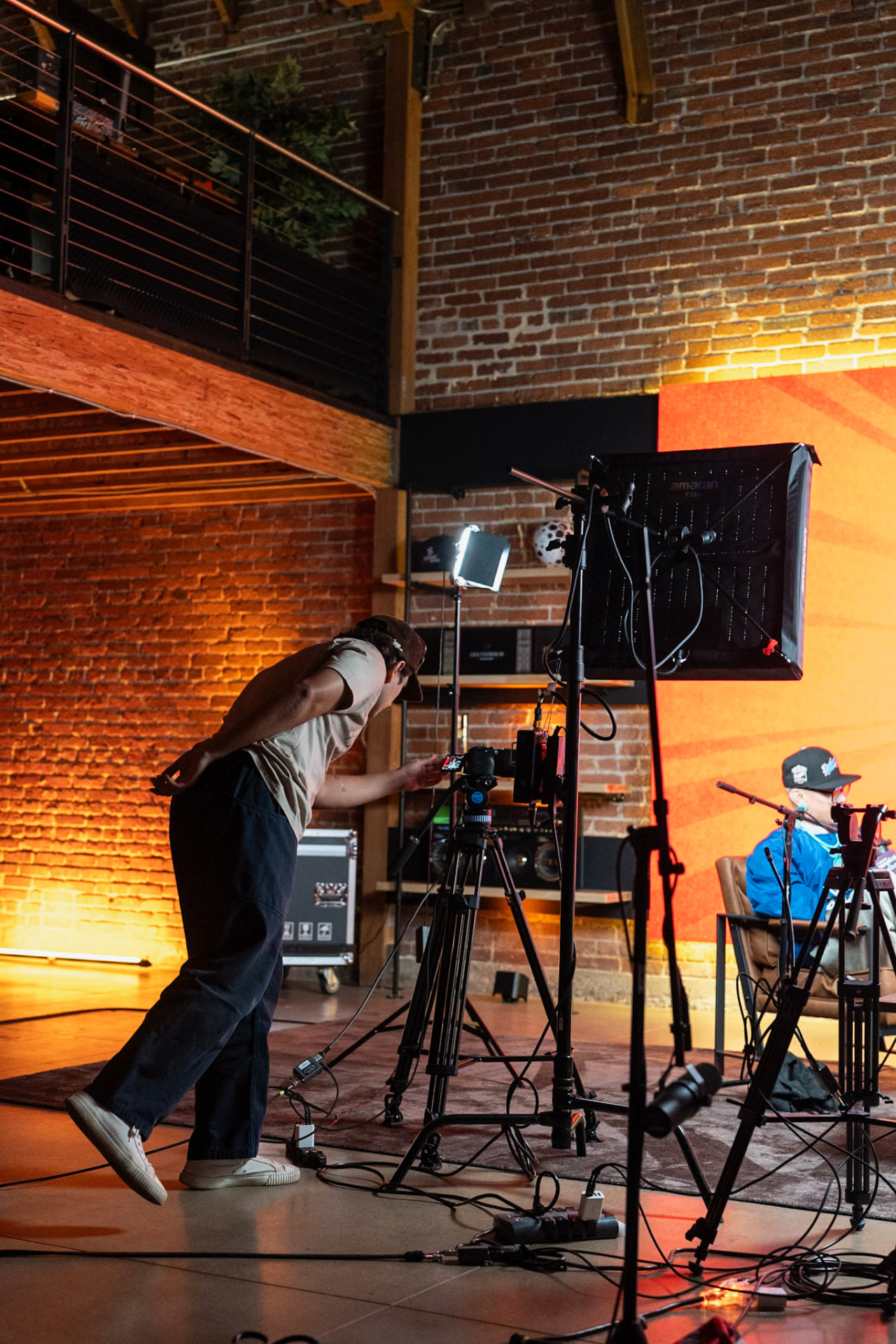 A crew member adjusting the studio camera
